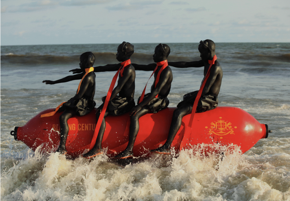 Four figures on a red buoy. climate-performance-art-choreographies-of-collapse